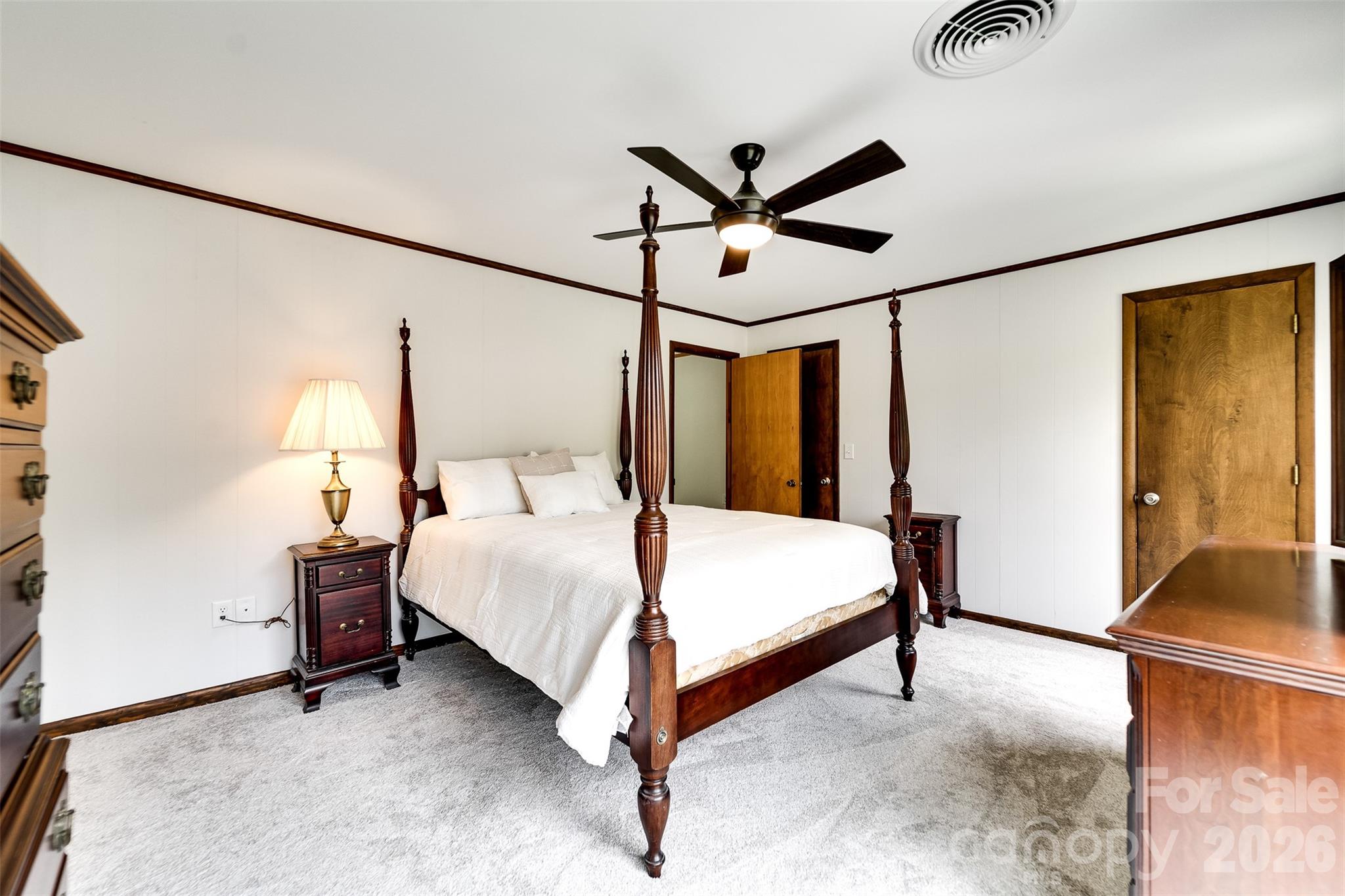 181 Fisher Crk Road Sylva, NC 28779 - Photo 30 of 48 a bedroom with a bed and wooden floor