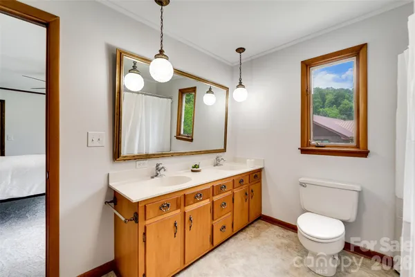 a bathroom with a toilet sink and mirror