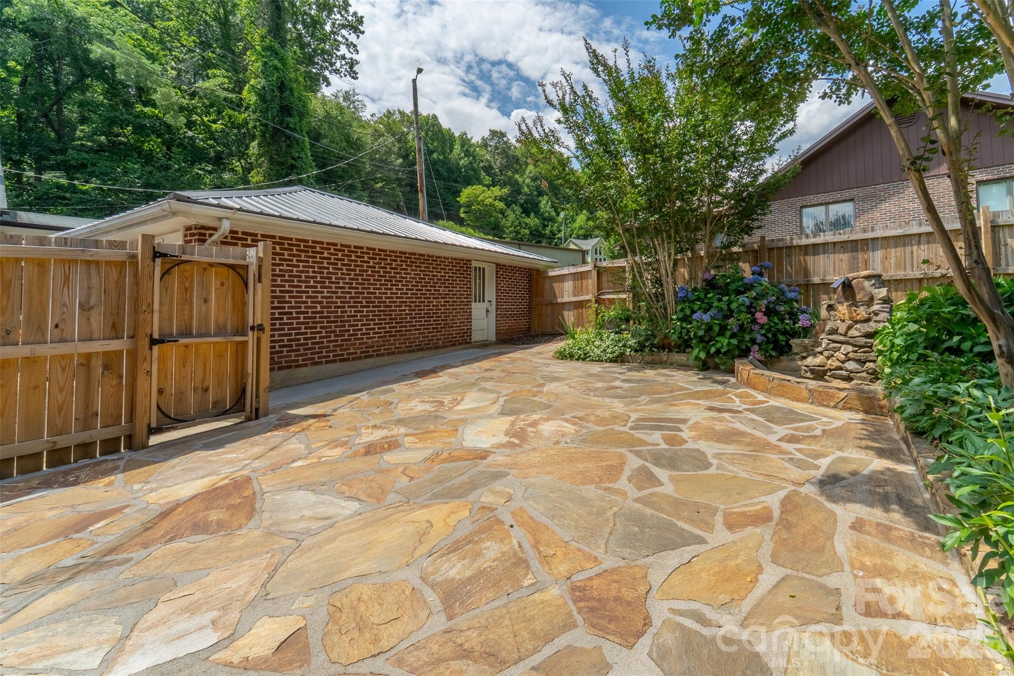 181 Fisher Crk Road Sylva, NC 28779 - Photo 32 of 48 a front view of a house with a garden
