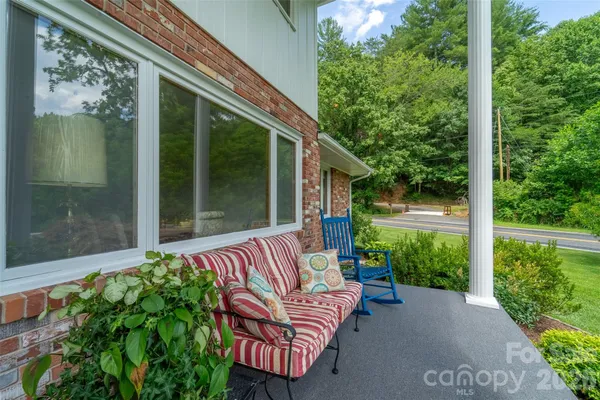 a balcony with furniture and garden view