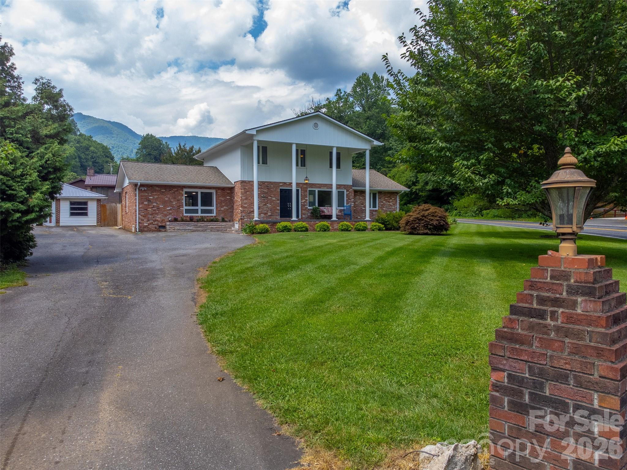 181 Fisher Crk Road Sylva, NC 28779 - Photo 45 of 48 a front view of a house with a yard and green space