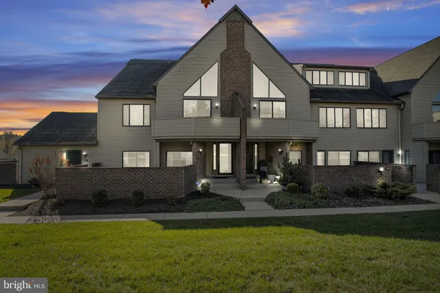 a front view of a house with a yard table and chairs