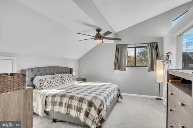 a bedroom with a dresser and a chandelier