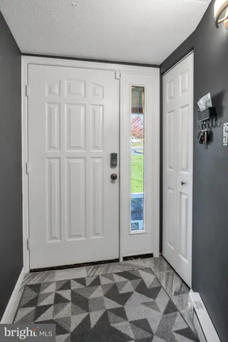 a view of an entryway with wooden floor