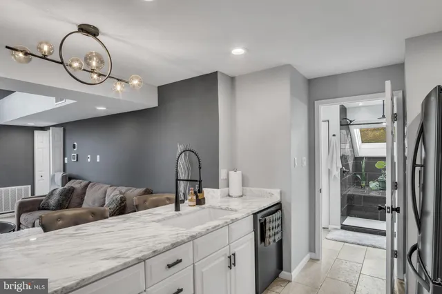 a bathroom with a granite countertop sink a mirror and a shower