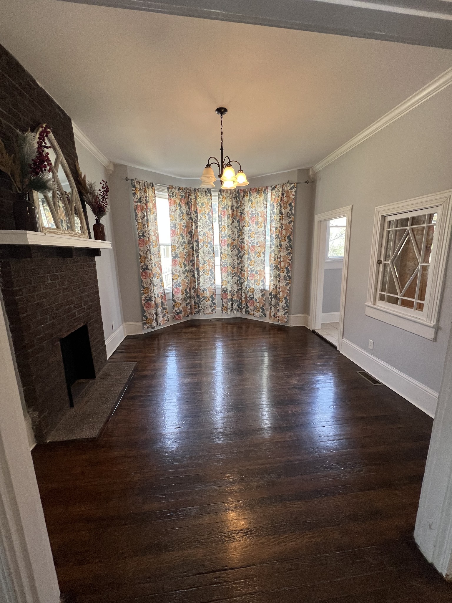 201 Pleasant Street Mount Pleasant, TN 38474 - Photo 16 of 38 a view of an empty room with wooden floor and a window