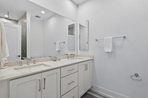 a bathroom with a double vanity sink and mirror