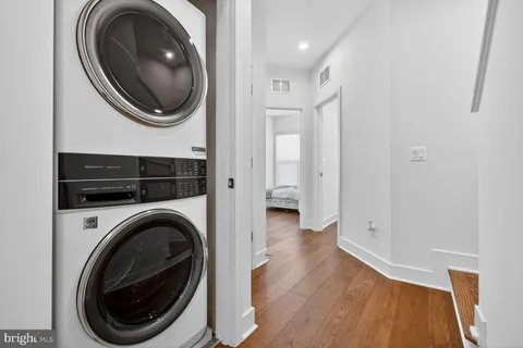 a view of a hallway with washer and dryer