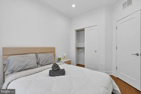 a bedroom with a bed and a lamp