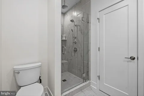 a bathroom with a shower a toilet and a sink