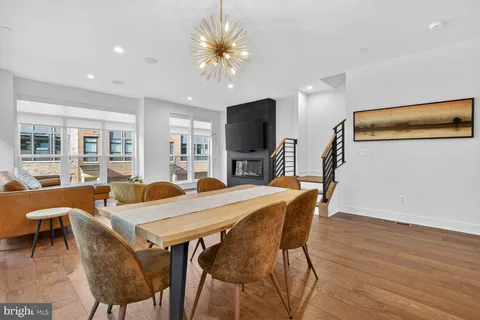 a view of a dining room with furniture and wooden floor