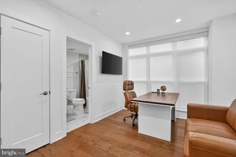 a work room with furniture and a flat screen tv