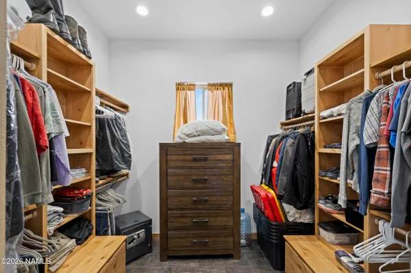 a view of walk in closet with clothes