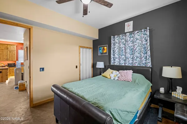 a bedroom with a bed and a lamp on table