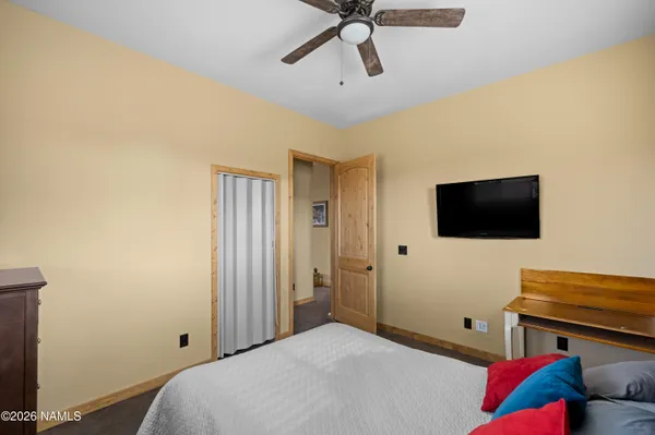 a bedroom with a bed and a flat screen tv