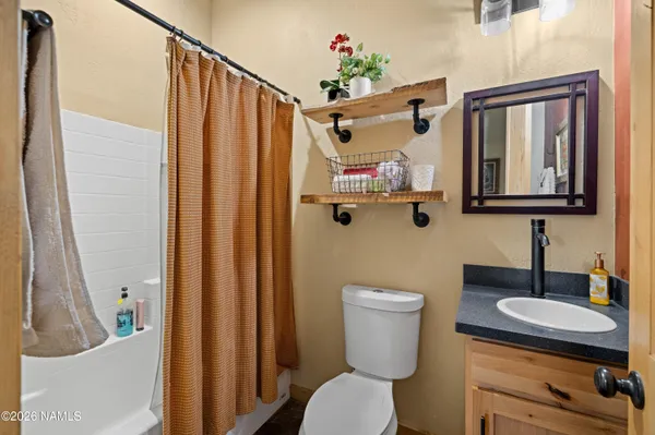 a bathroom with a toilet a sink and a mirror