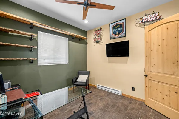 a view of a livingroom with workspace and a window