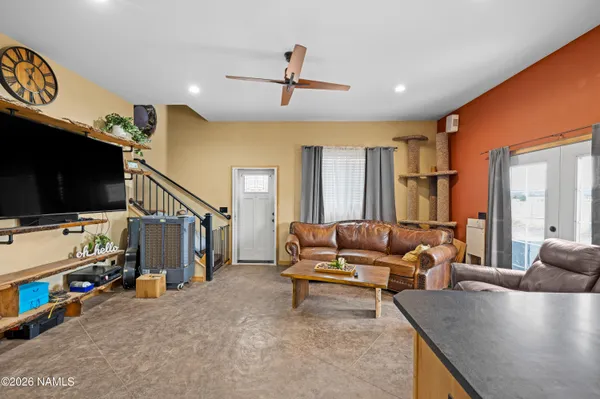 a living room with furniture and a flat screen tv