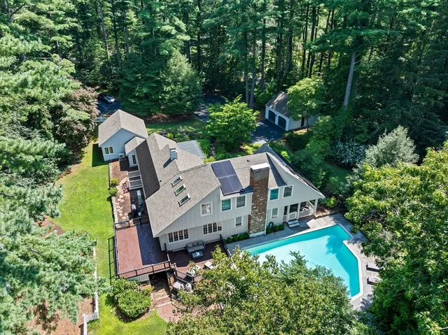 an aerial view of a house with roof deck and garden
