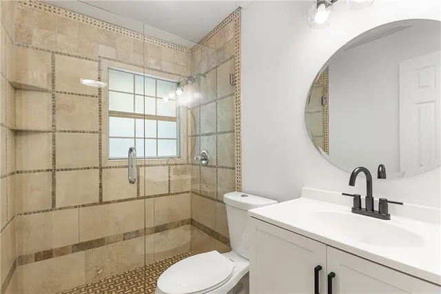 a bathroom with a sink toilet and shower