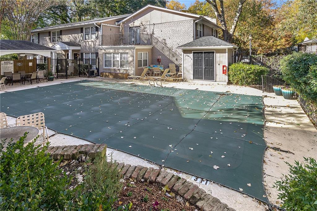 2232 Dunseath Avenue Northwest, Unit 309 Atlanta, GA 30318 - Photo 23 of 25 a front view of a house with a yard