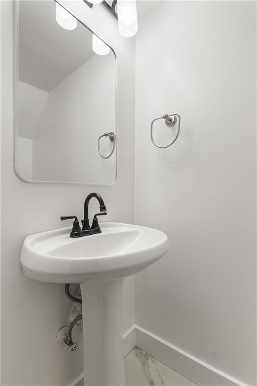 2232 Dunseath Avenue Northwest, Unit 309 Atlanta, GA 30318 - Photo 10 of 25 a bathroom with a sink a toilet and a mirror