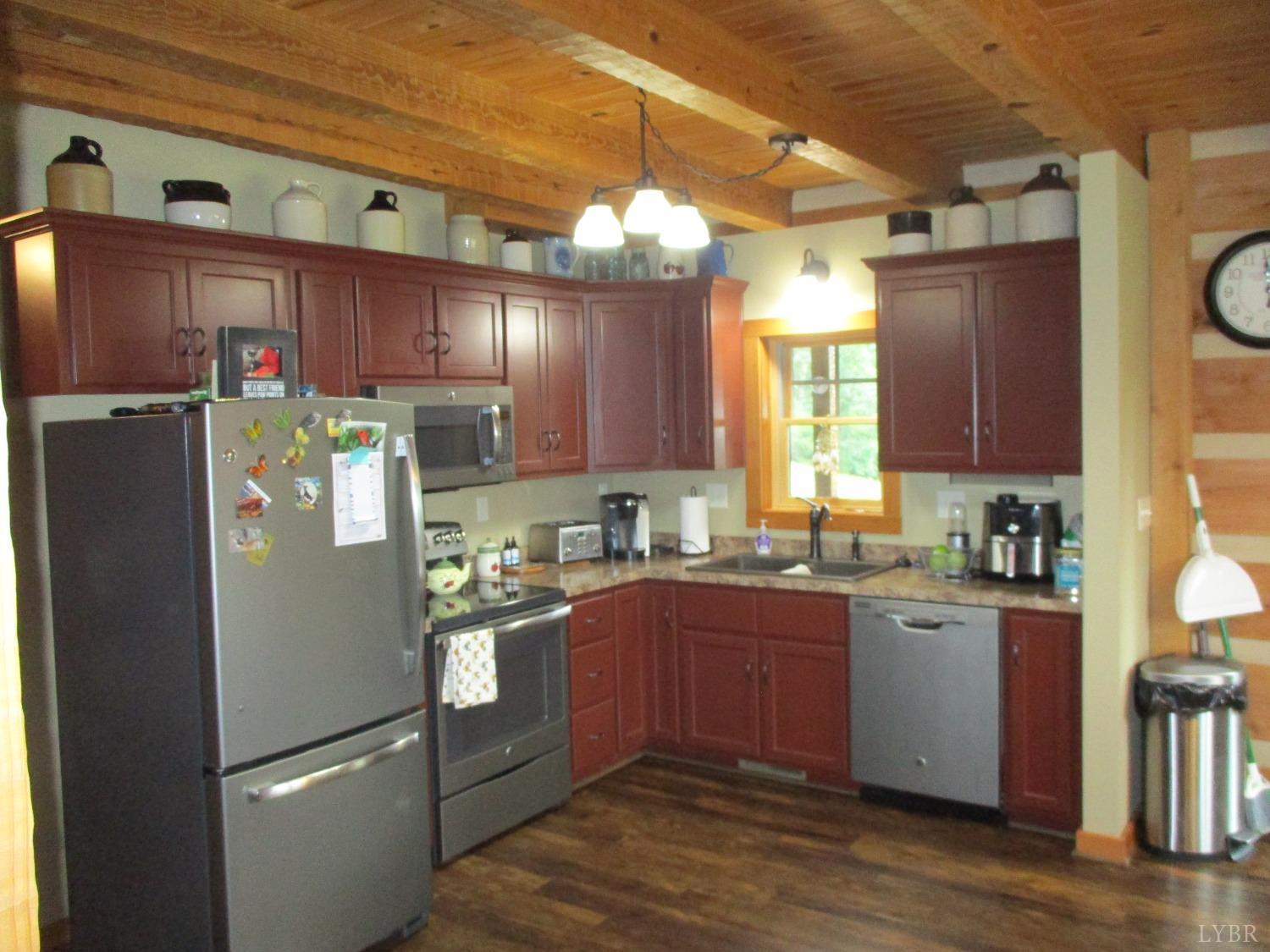 3804 Saunders Road Vinton, VA 24179 - Photo 6 of 50 a kitchen with stainless steel appliances granite countertop a refrigerator a sink dishwasher a stove with wooden cabinets and floor