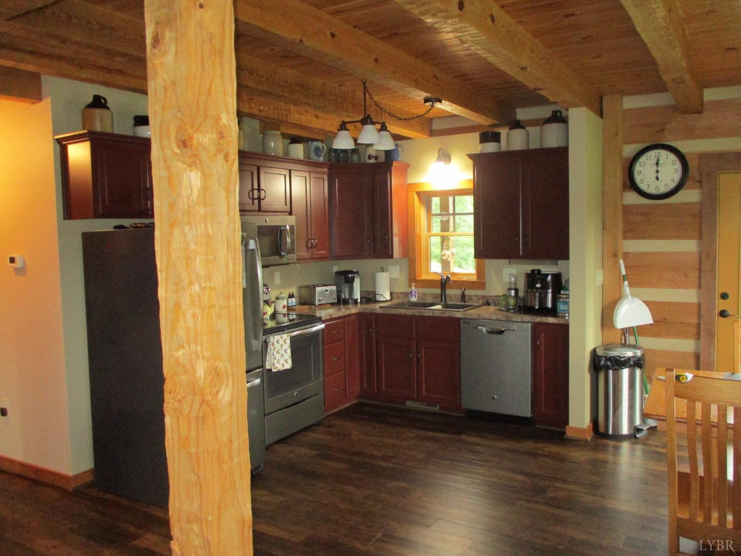 3804 Saunders Road Vinton, VA 24179 - Photo 10 of 50 a kitchen with granite countertop a refrigerator a sink dishwasher a stove and a dining table with wooden floor