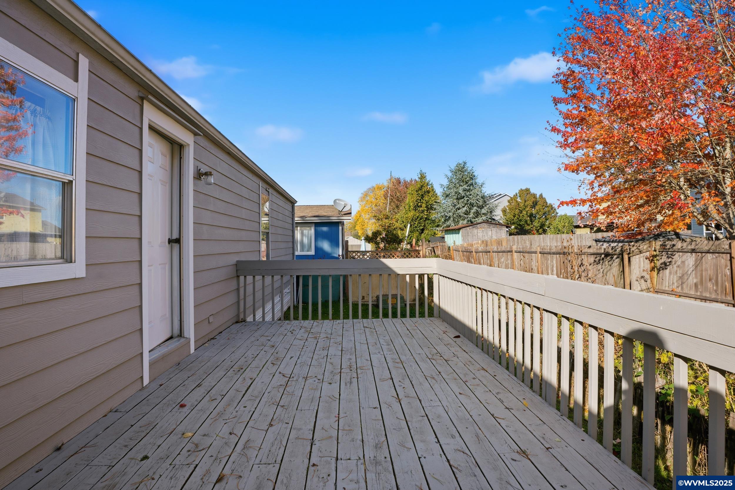 277 Edwards Road, Unit 145 Monmouth, OR 97361 - Photo 29 of 47 a view of deck with wooden floor and fence with a large trees
