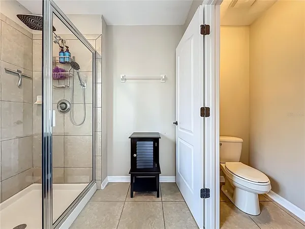 a bathroom with a shower and a toilet