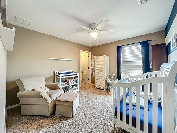 a bedroom with furniture and a large window