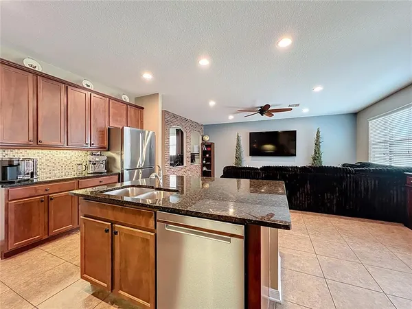 a kitchen with stainless steel appliances granite countertop a sink and stove