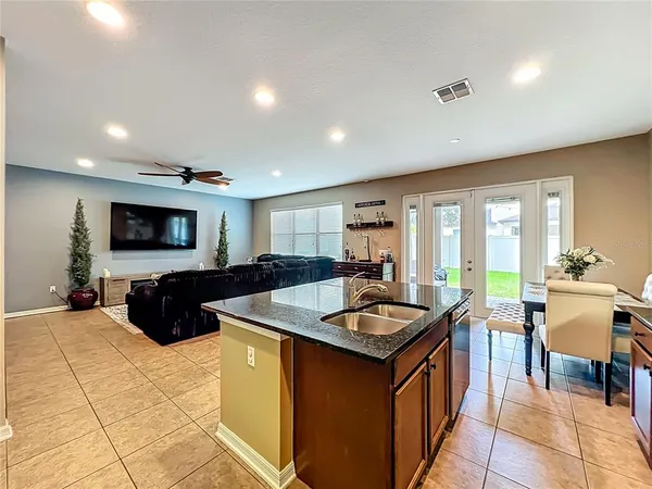 a kitchen with stainless steel appliances granite countertop a sink and a refrigerator