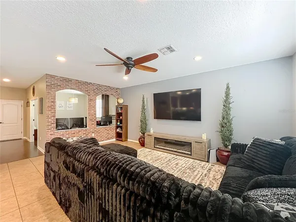 a spacious bedroom with a bed and a flat screen tv