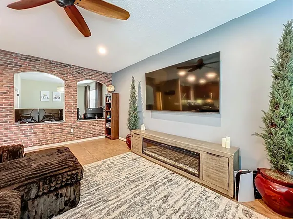 a bedroom with furniture and a flat screen tv