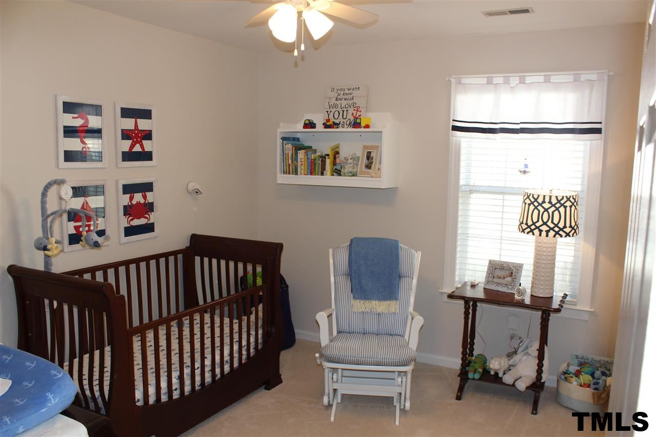 1045 Mills Street Raleigh, NC 27608 - Photo 14 of 20 a bedroom with furniture and a window
