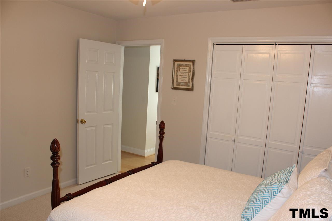 1045 Mills Street Raleigh, NC 27608 - Photo 17 of 20 a bedroom with a bed and a shower