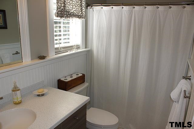 1045 Mills Street Raleigh, NC 27608 - Photo 18 of 20 a bathroom with a sink and toilet
