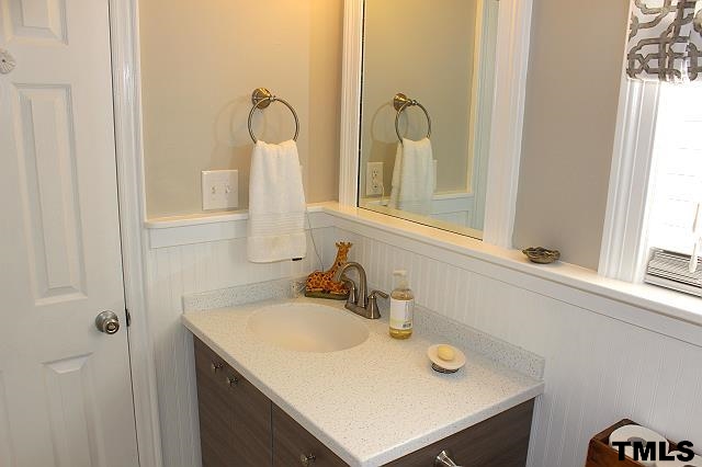 1045 Mills Street Raleigh, NC 27608 - Photo 19 of 20 a bathroom with a sink and a mirror