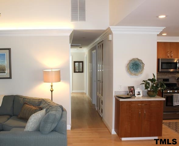 1045 Mills Street Raleigh, NC 27608 - Photo 2 of 20 a living room with furniture and a flat screen tv