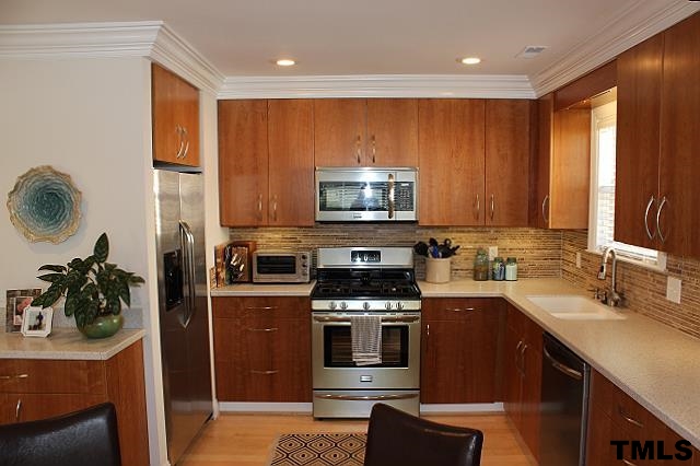 1045 Mills Street Raleigh, NC 27608 - Photo 7 of 20 a kitchen with stainless steel appliances granite countertop a stove a sink and a microwave