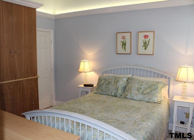 1045 Mills Street Raleigh, NC 27608 - Photo 10 of 20 a bedroom with a bed and a window