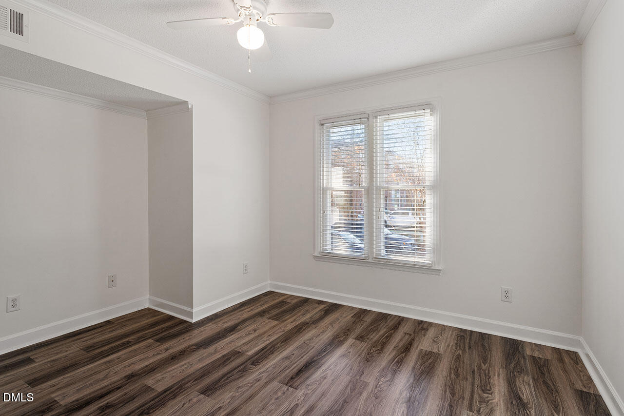 2306 Stafford Avenue, Unit D Raleigh, NC 27607 - Photo 17 of 24 a view of an empty room with wooden floor and a window
