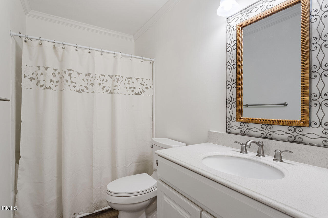 2306 Stafford Avenue, Unit D Raleigh, NC 27607 - Photo 19 of 24 a bathroom with a granite countertop sink toilet and a mirror