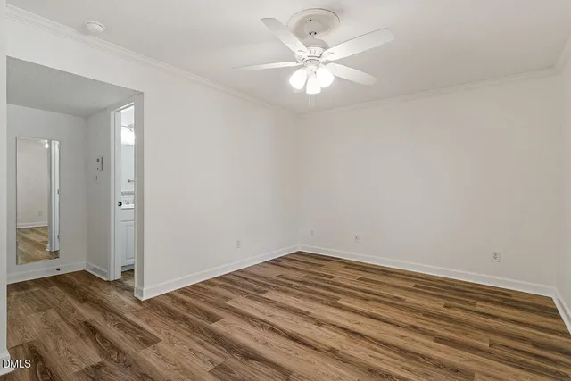a view of a room with wooden floor and chandelier fan