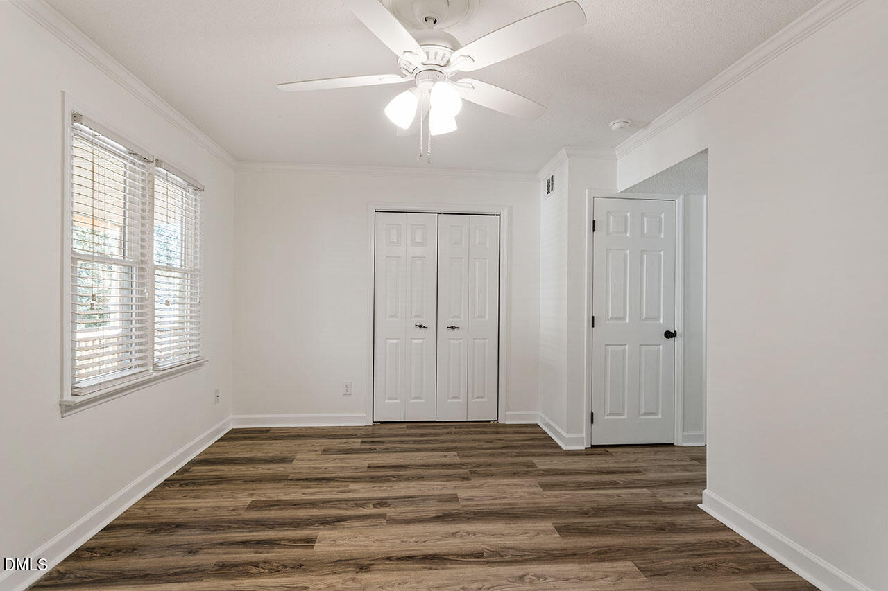 2306 Stafford Avenue, Unit D Raleigh, NC 27607 - Photo 22 of 24 a view of a livingroom with wooden floor and a ceiling fan