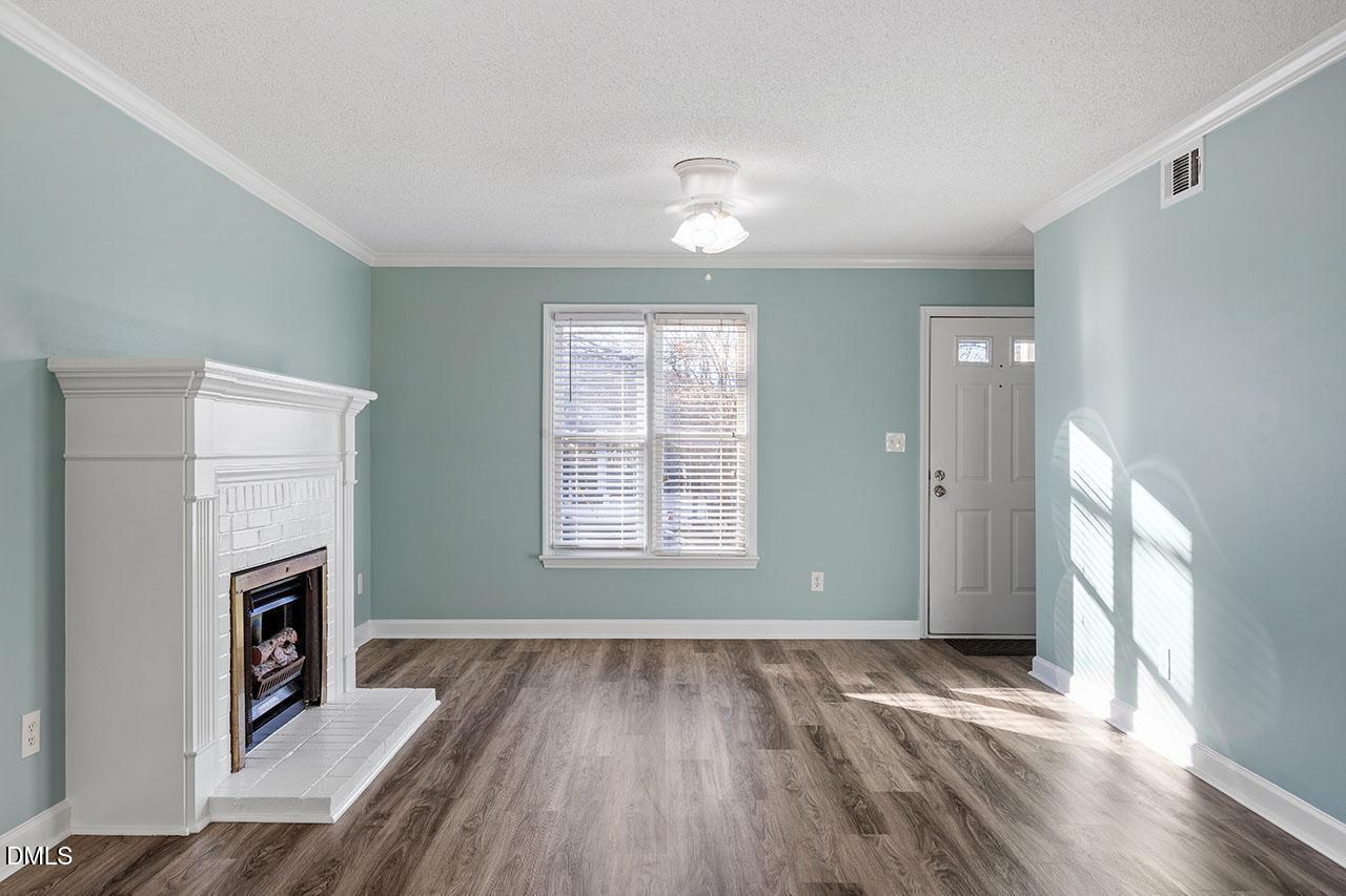 2306 Stafford Avenue, Unit D Raleigh, NC 27607 - Photo 4 of 24 a view of an empty room with wooden floor and a window