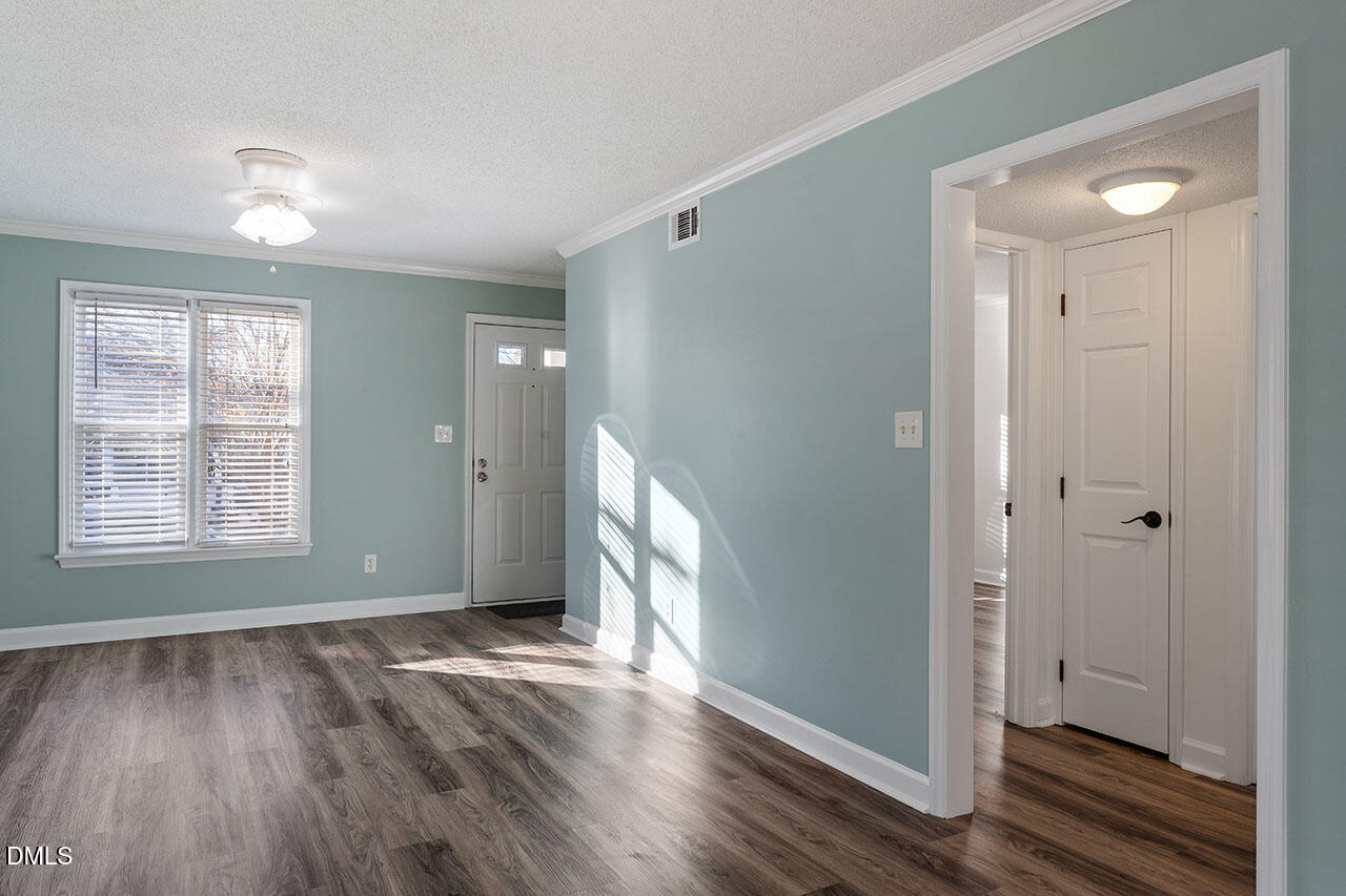 2306 Stafford Avenue, Unit D Raleigh, NC 27607 - Photo 5 of 24 a view of an empty room with wooden floor and a window