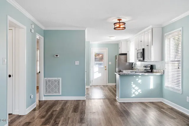 a room with a wooden floor and entryway