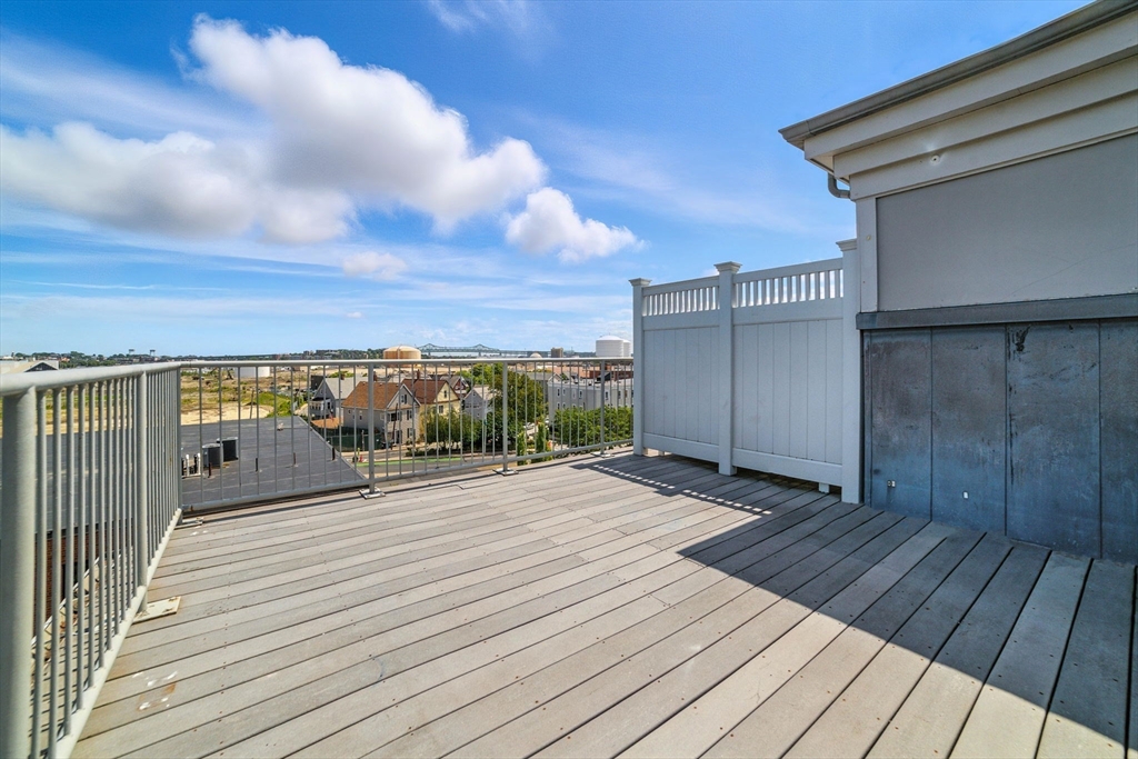 210 Broadway, Unit 406 Everett, MA 02149 - Photo 17 of 33 a view of a balcony with wooden floor